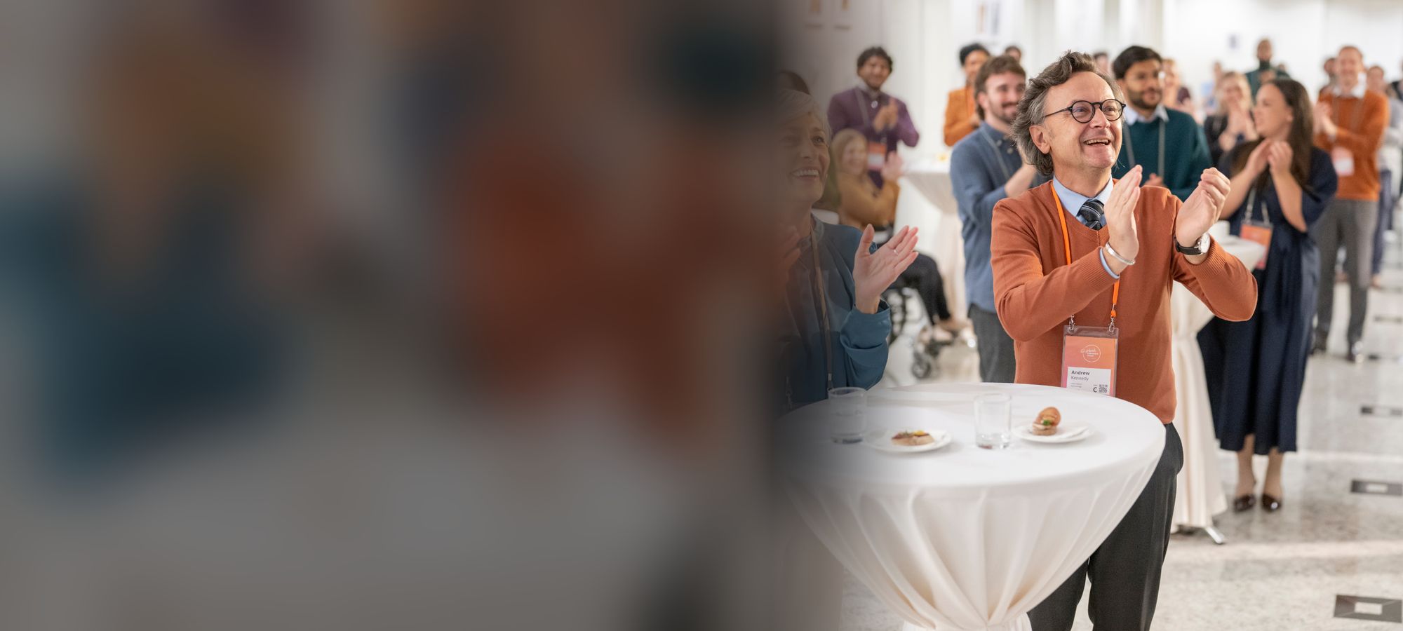 Attendees applauding at a business networking event